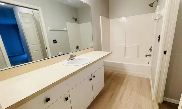 a bathroom with a sink a mirror and a shower
