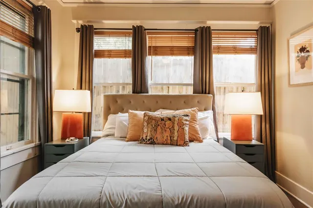 a bedroom with a large bed and a large window