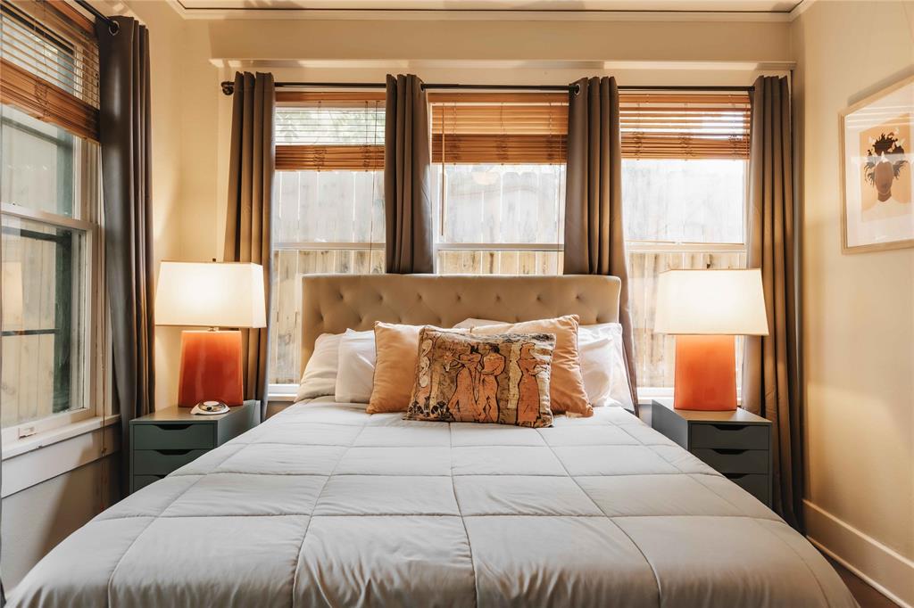 2623 Salado Street Austin, TX 78705 - Photo 22 of 36 a bedroom with a large bed and a large window