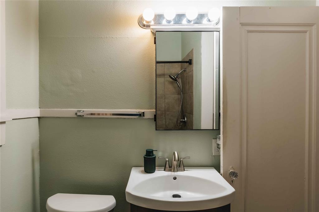 2623 Salado Street Austin, TX 78705 - Photo 25 of 36 a bathroom with a toilet sink and mirror