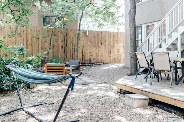 a backyard of a house with barbeque oven table and chairs