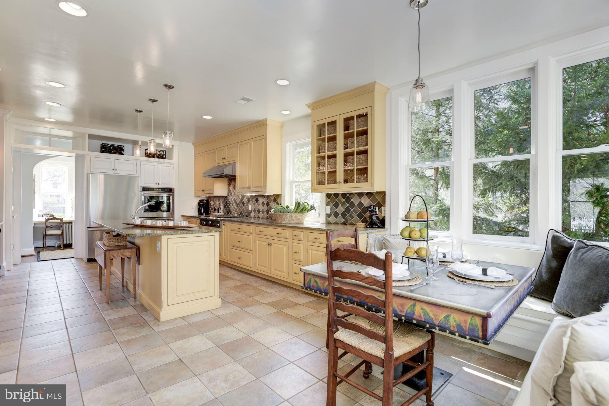 3807 Williams Lane Chevy Chase, MD 20815 - Photo 13 of 30 a dining room with stainless steel appliances kitchen island granite countertop a table and chairs
