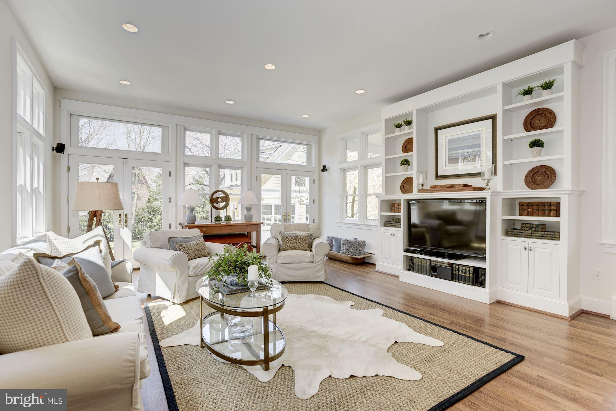 3807 Williams Lane Chevy Chase, MD 20815 - Photo 17 of 30 a living room with furniture a flat screen tv and a floor to ceiling window