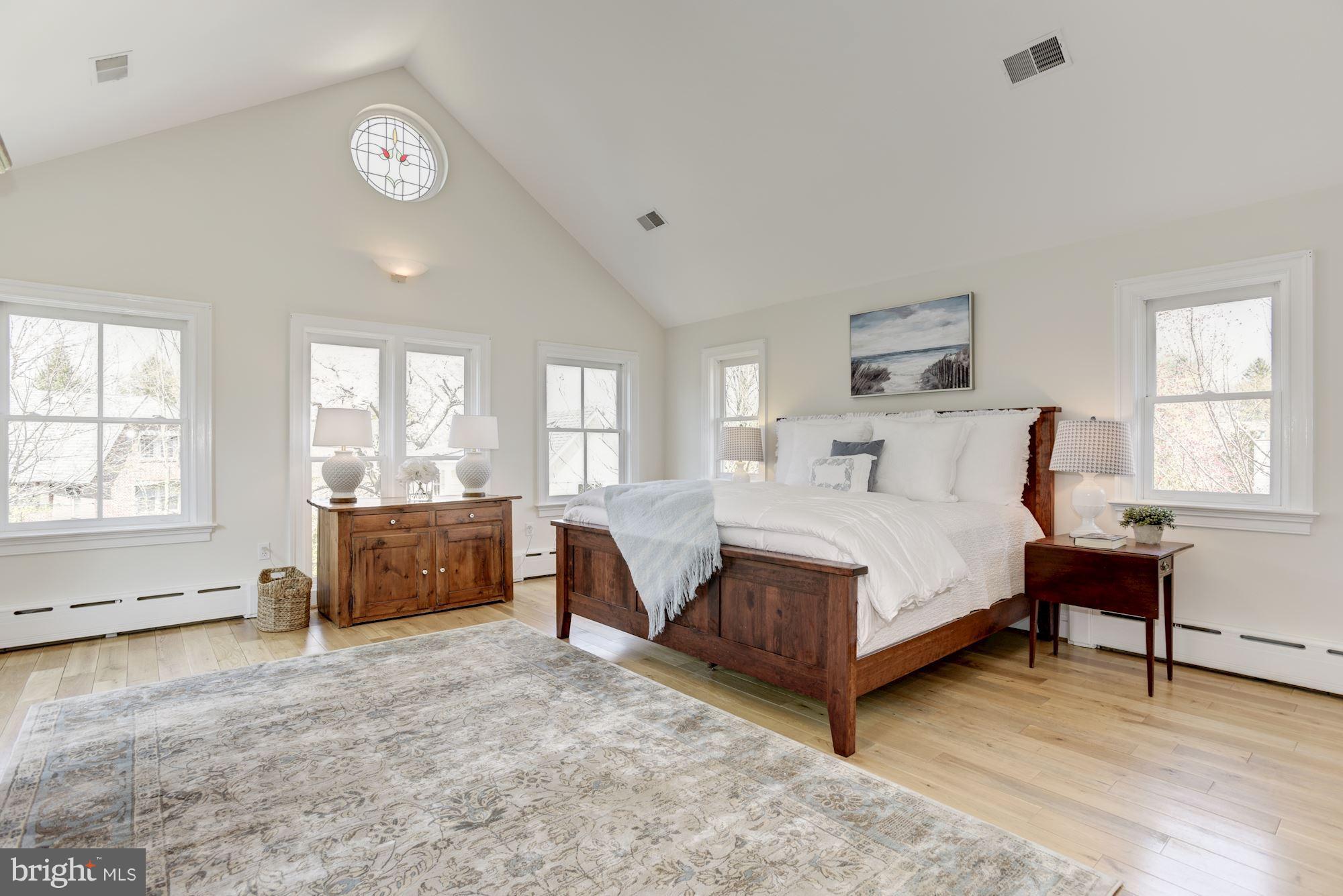 3807 Williams Lane Chevy Chase, MD 20815 - Photo 19 of 30 a spacious bedroom with a large bed and a large window