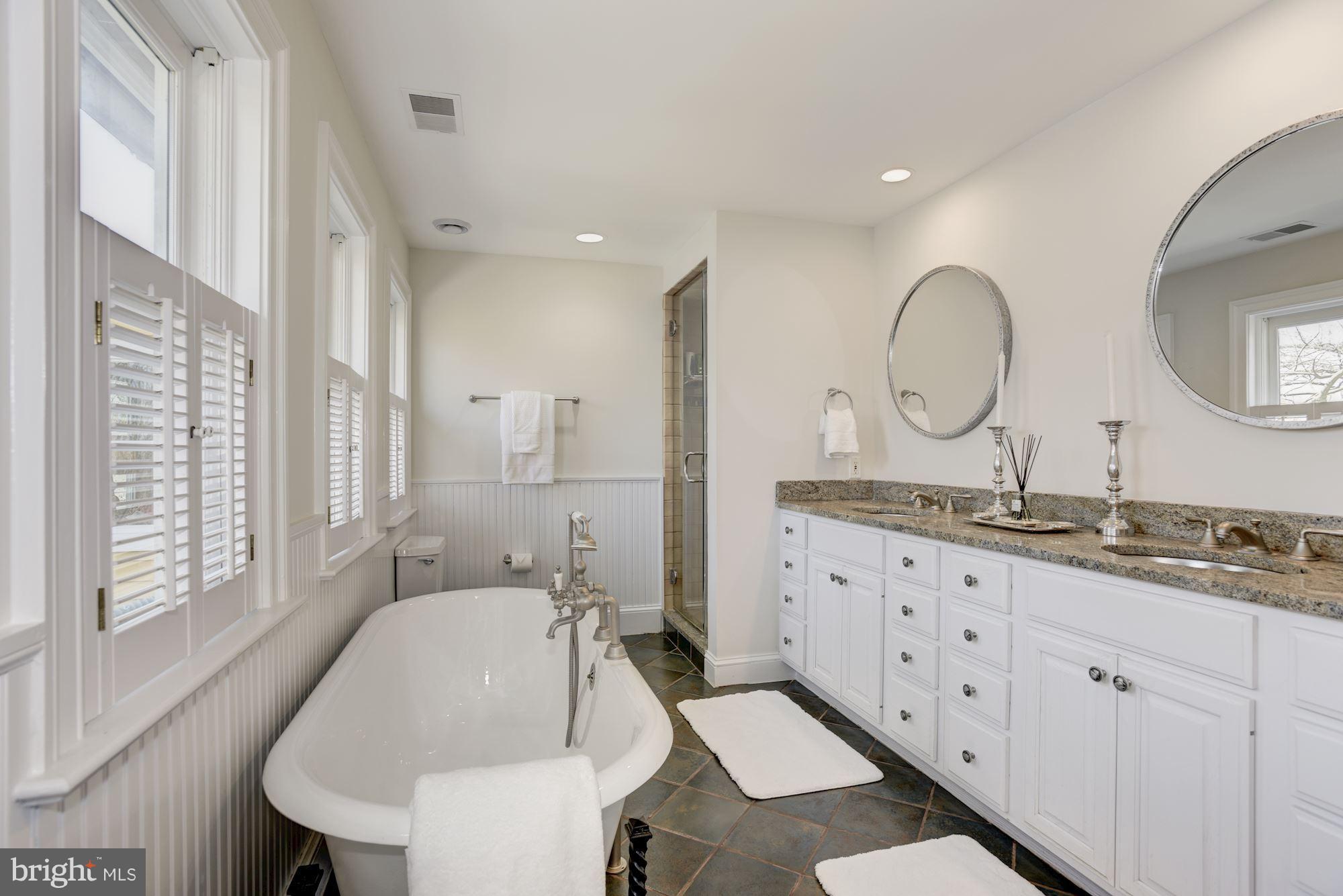 3807 Williams Lane Chevy Chase, MD 20815 - Photo 20 of 30 a bathroom with double vanity sink a mirror and a shower