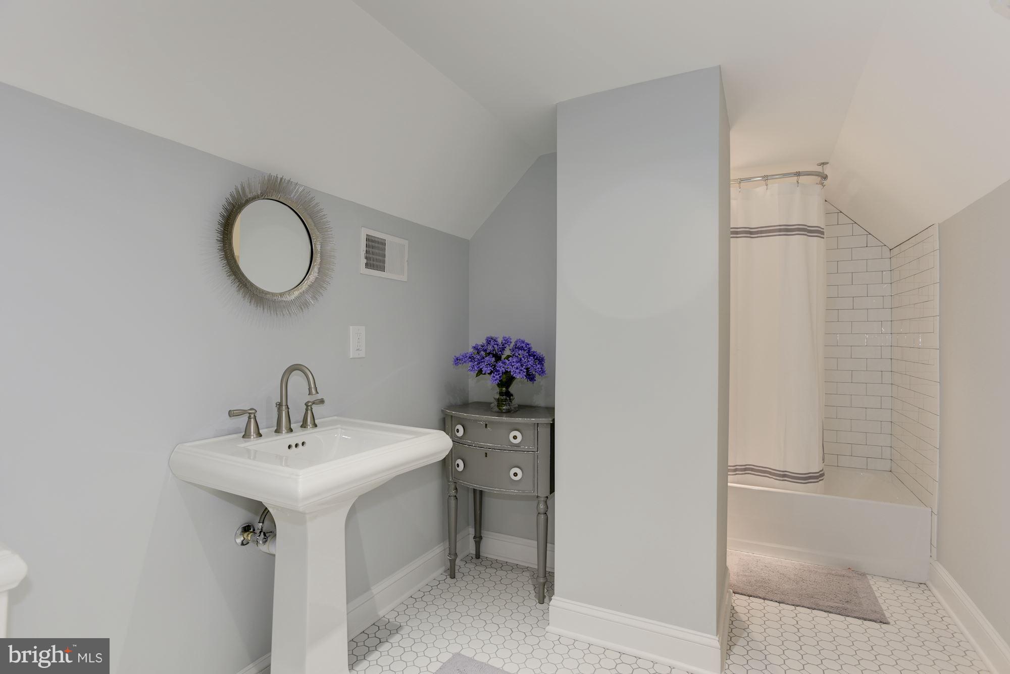 3807 Williams Lane Chevy Chase, MD 20815 - Photo 25 of 30 a bathroom with a sink mirror and a shower