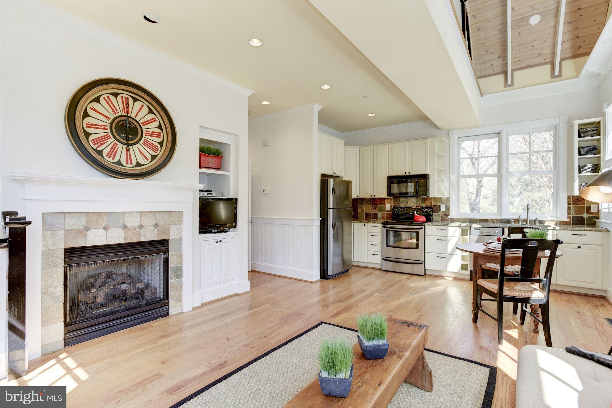 3807 Williams Lane Chevy Chase, MD 20815 - Photo 28 of 30 a living room with furniture a kitchen area with a fireplace and a large window