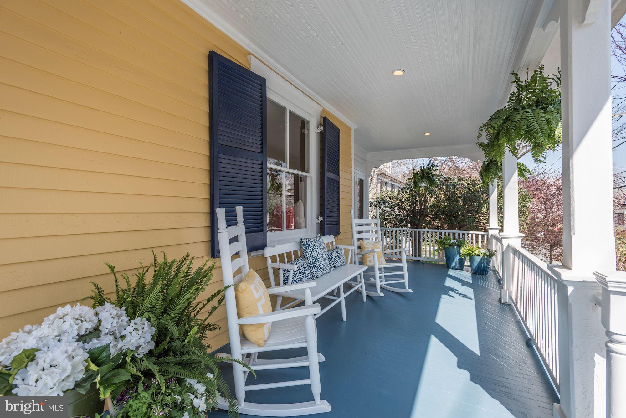 3807 Williams Lane Chevy Chase, MD 20815 - Photo 4 of 30 a view of a patio with couches chairs potted plants and floor to ceiling window and potted plants