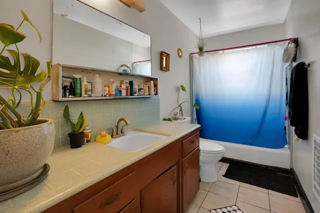 a kitchen with a sink a stove and cabinets