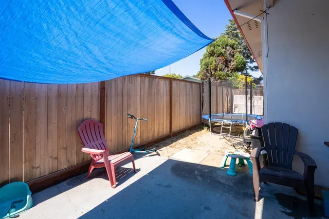 a view of a backyard with a tub and chairs