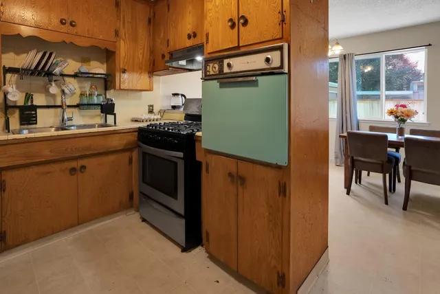 a kitchen with a refrigerator and a sink