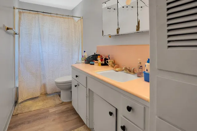 a bathroom with a sink toilet and shower