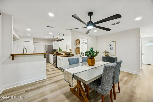 a view of a dining room with furniture and wooden floor