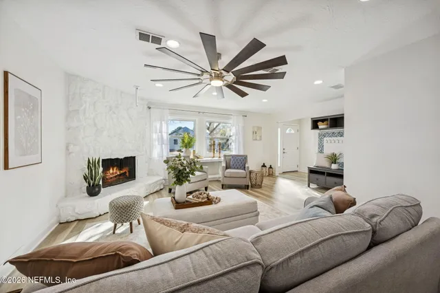 a living room with furniture and a fireplace