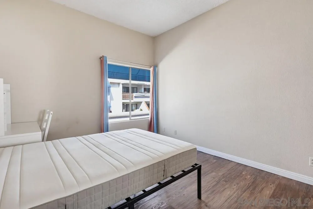8324 Regents Road, Unit 2E San Diego, CA 92122 - Photo 19 of 31 a bedroom with a bed and a window
