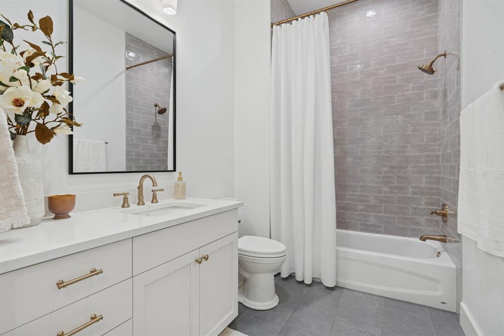 8008 Ben Day Murrin Road Fort Worth, TX 76126 - Photo 25 of 40 a bathroom with a double vanity sink toilet and shower