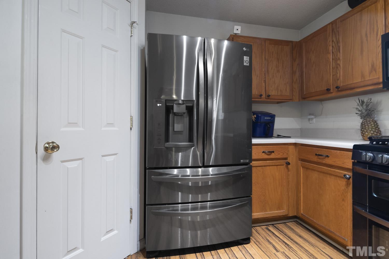 5904 Rivercliff Court Raleigh, NC 27610 - Photo 12 of 30 a kitchen with stainless steel appliances granite countertop a refrigerator and a stove top oven