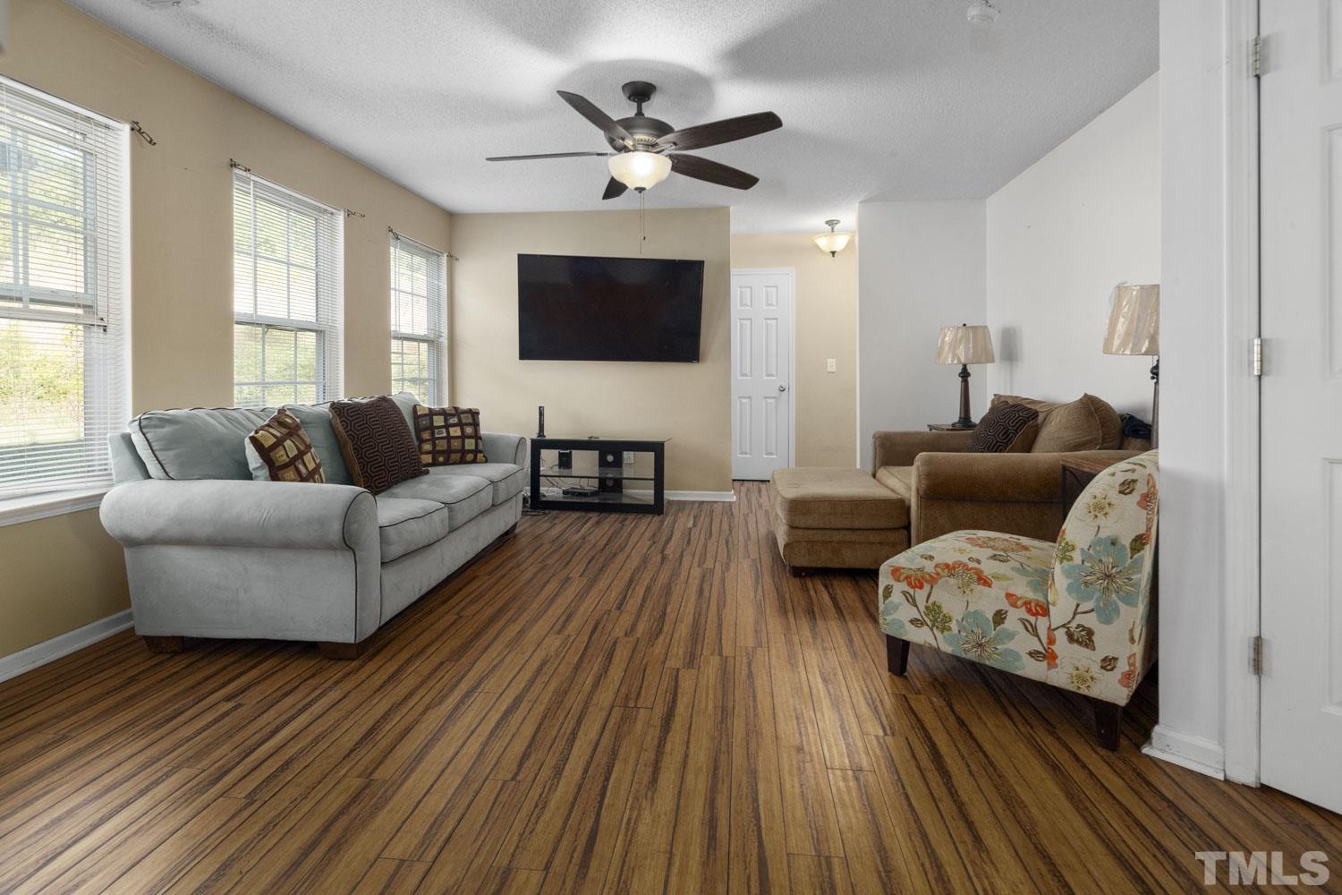 5904 Rivercliff Court Raleigh, NC 27610 - Photo 16 of 30 a living room with furniture and a flat screen tv