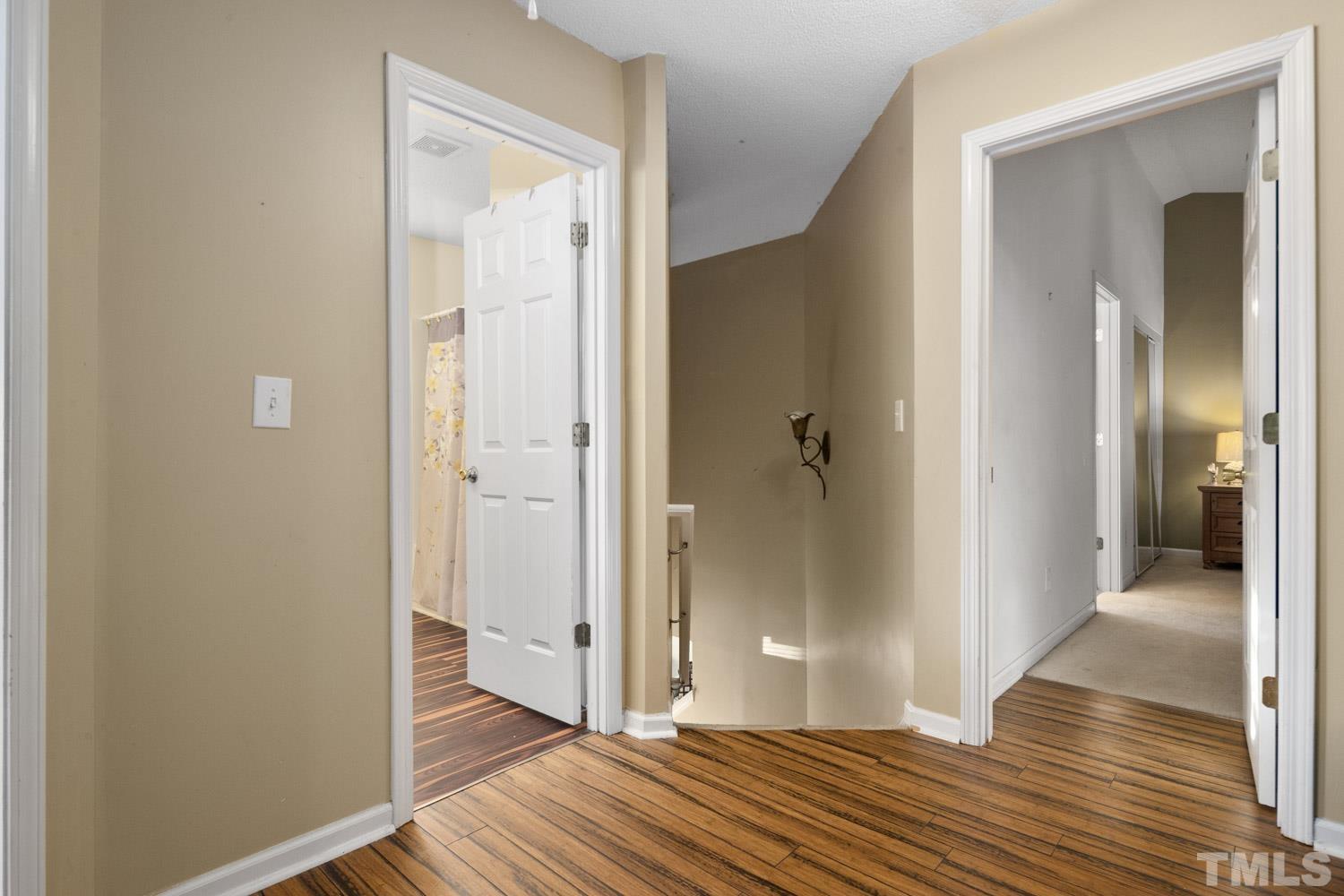 5904 Rivercliff Court Raleigh, NC 27610 - Photo 20 of 30 a view of a hallway with wooden floor and a bathroom