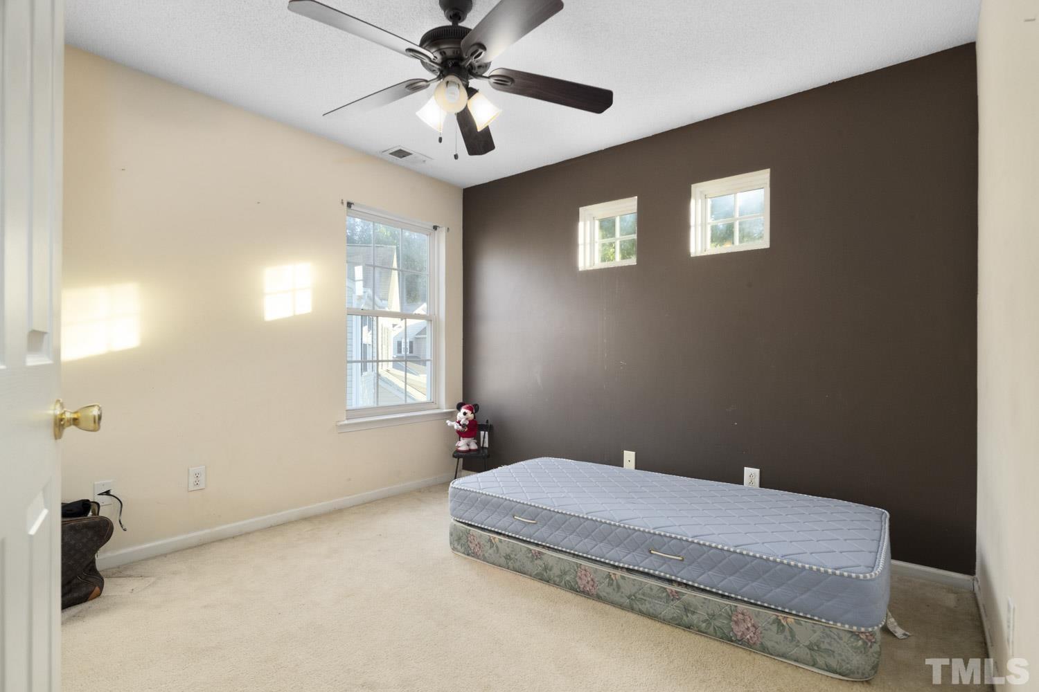 5904 Rivercliff Court Raleigh, NC 27610 - Photo 23 of 30 a bedroom with a bed and a chandelier