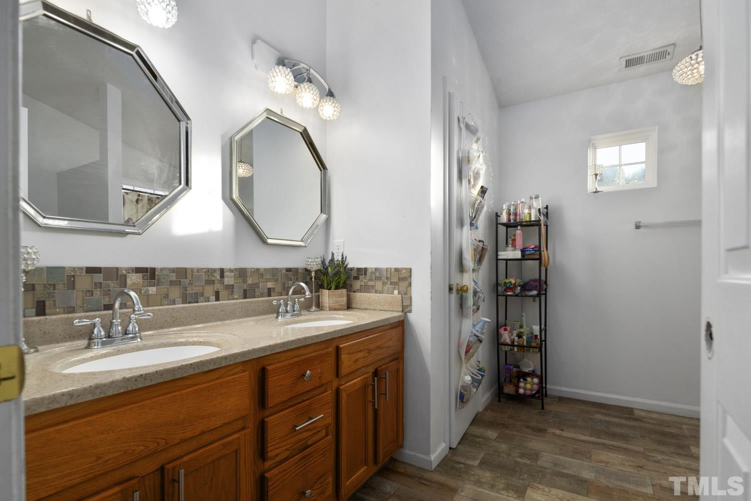 5904 Rivercliff Court Raleigh, NC 27610 - Photo 29 of 30 a spacious bathroom with a double vanity sink double and a mirror