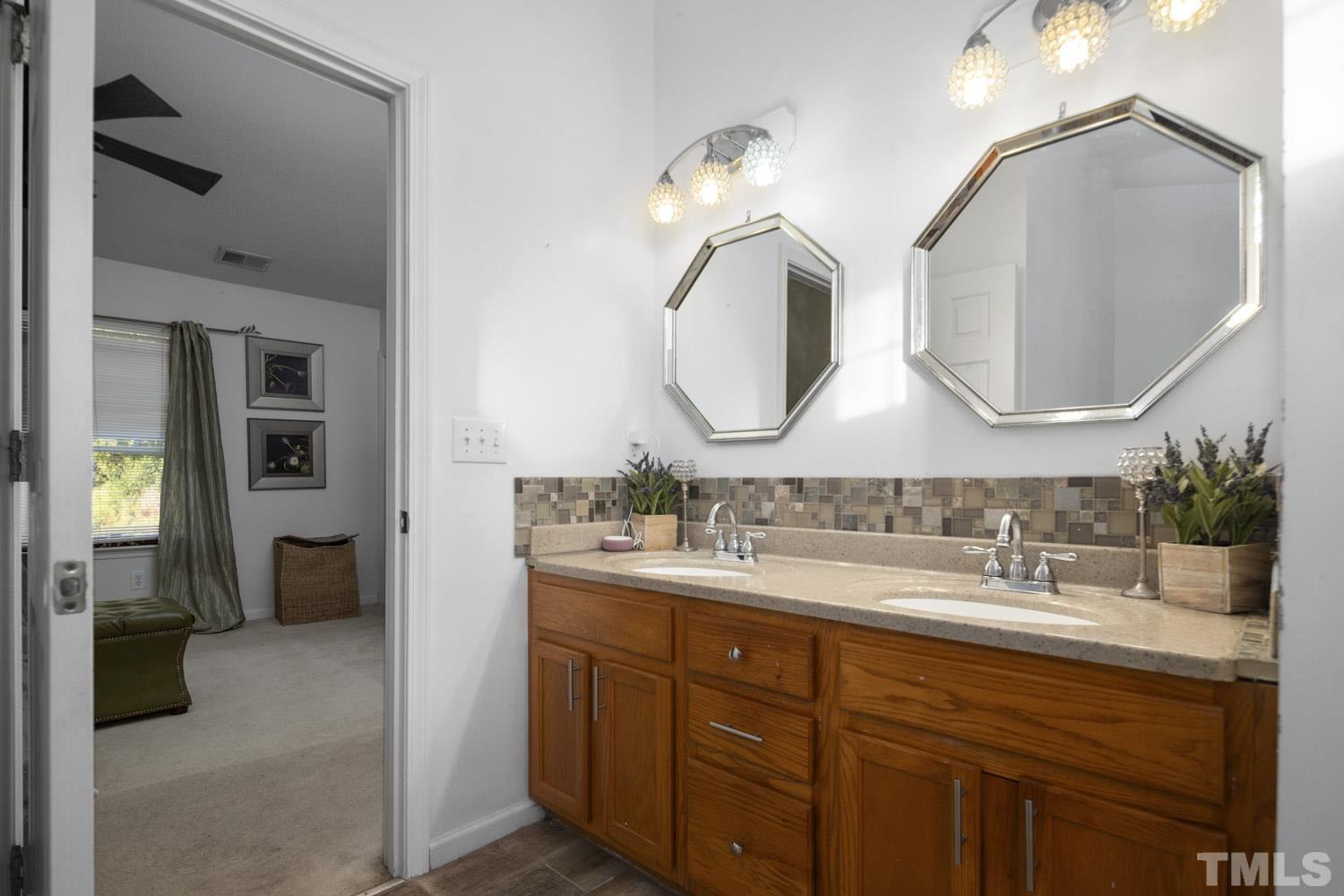 5904 Rivercliff Court Raleigh, NC 27610 - Photo 30 of 30 a bathroom with a double vanity sink and a mirror