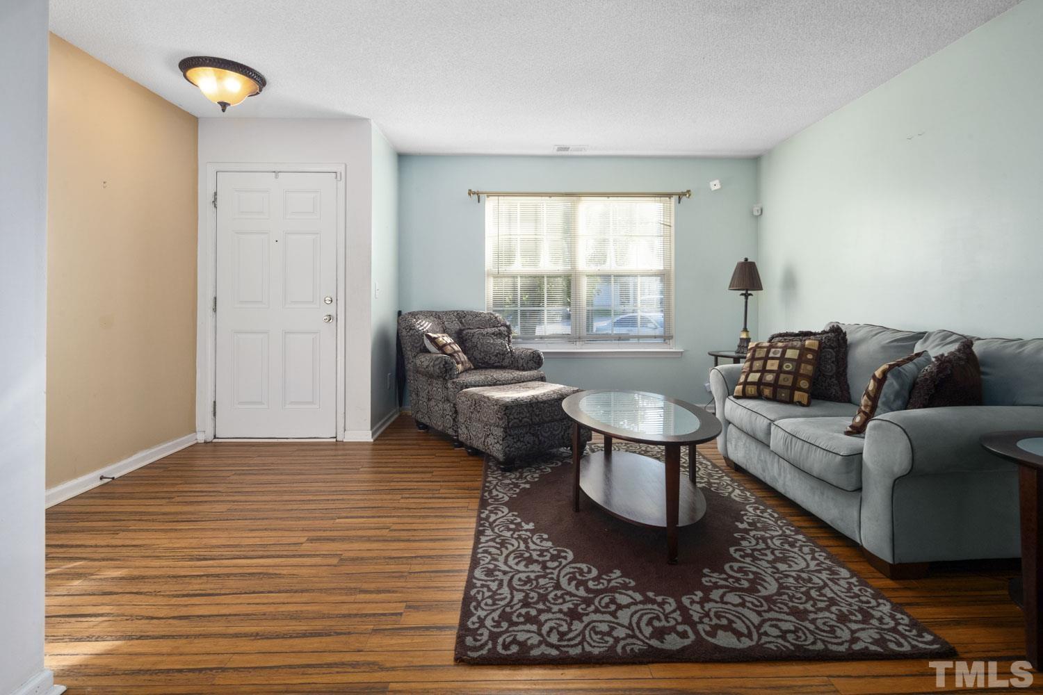 5904 Rivercliff Court Raleigh, NC 27610 - Photo 7 of 30 a living room with furniture and a rug