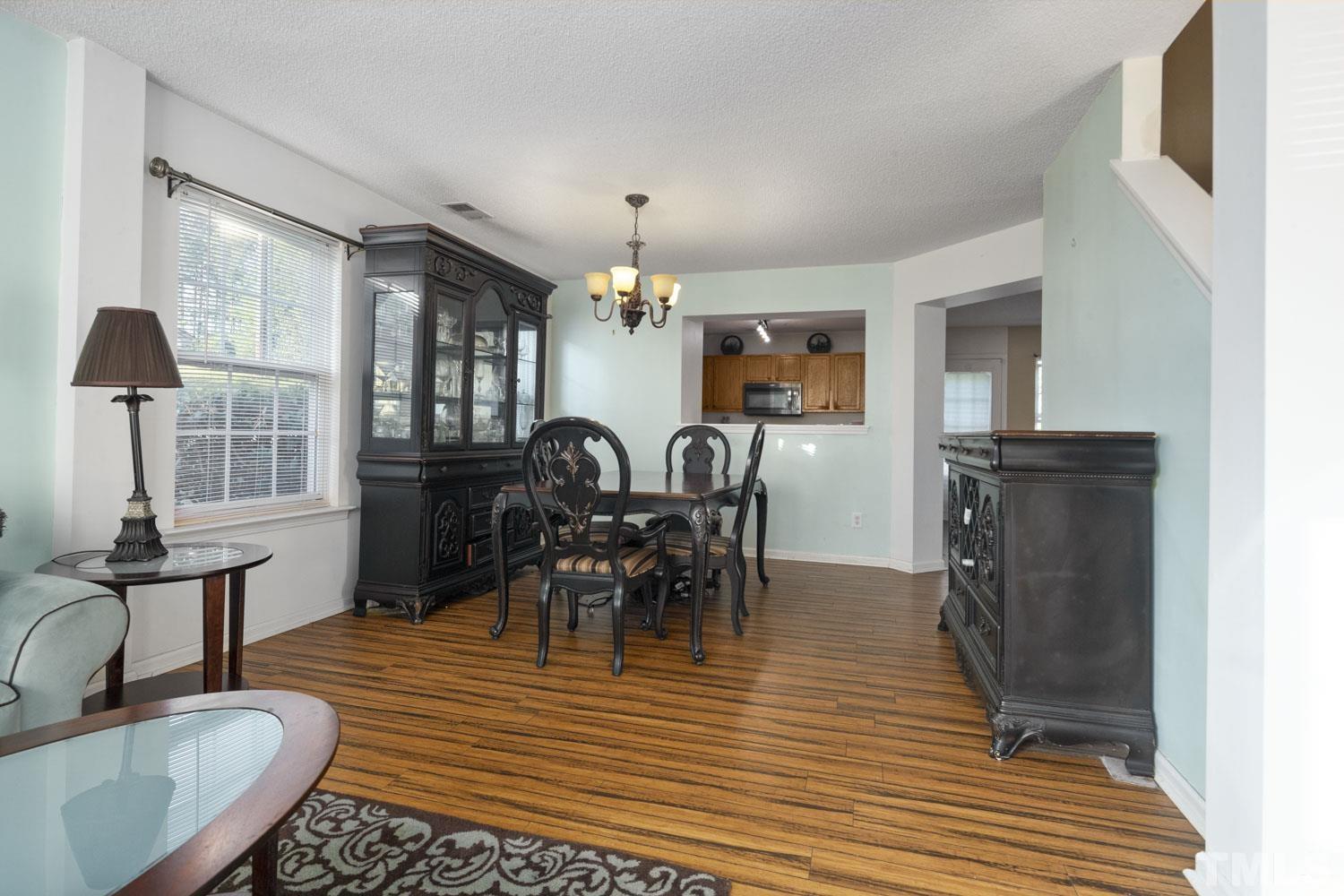5904 Rivercliff Court Raleigh, NC 27610 - Photo 8 of 30 a view of a dining room with furniture window and wooden floor