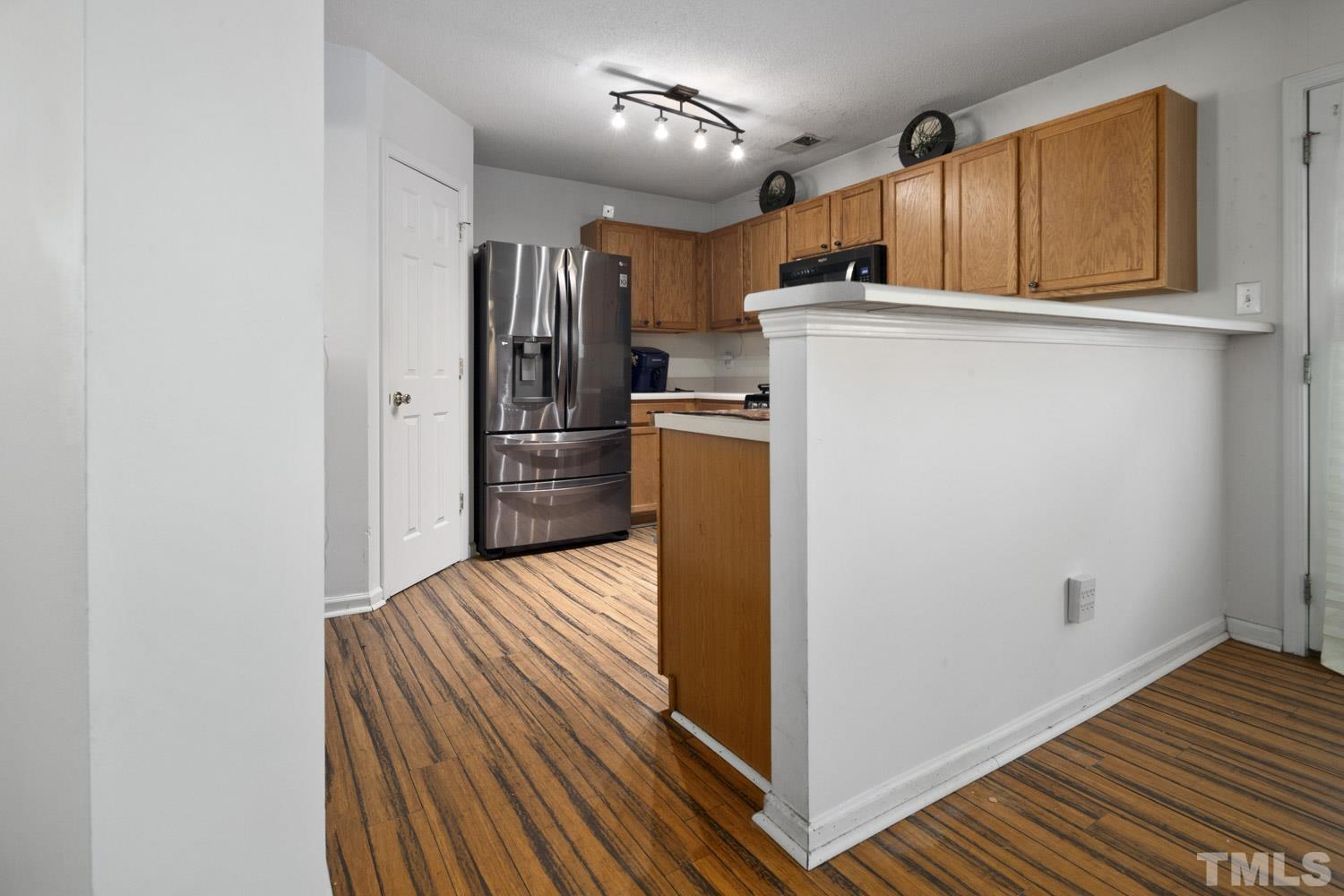 5904 Rivercliff Court Raleigh, NC 27610 - Photo 10 of 30 a kitchen with refrigerator and microwave