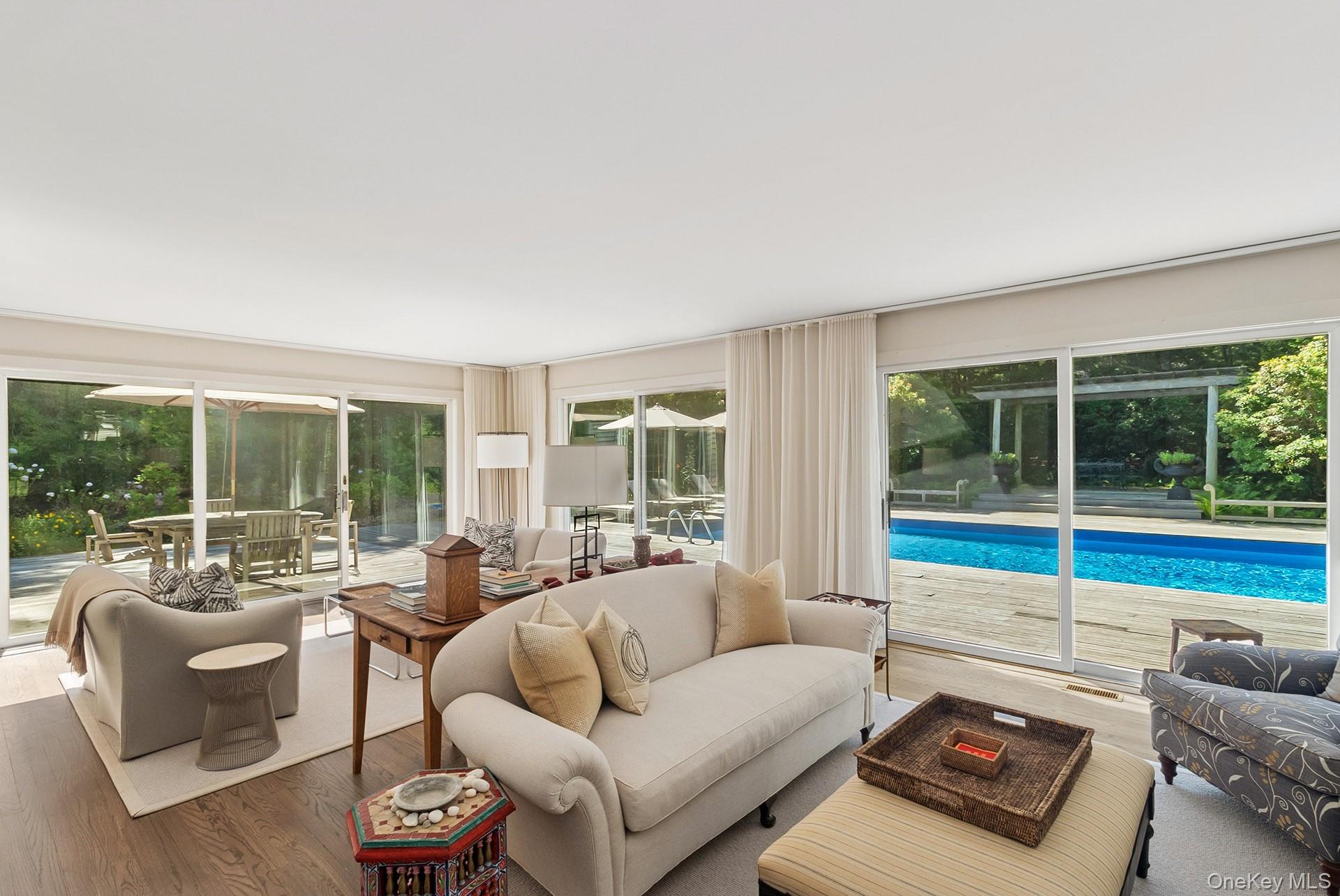 530 Hands Creek Road East Hampton, NY 11937 - Photo 3 of 47 Living area with wood finished floors and a sunroom