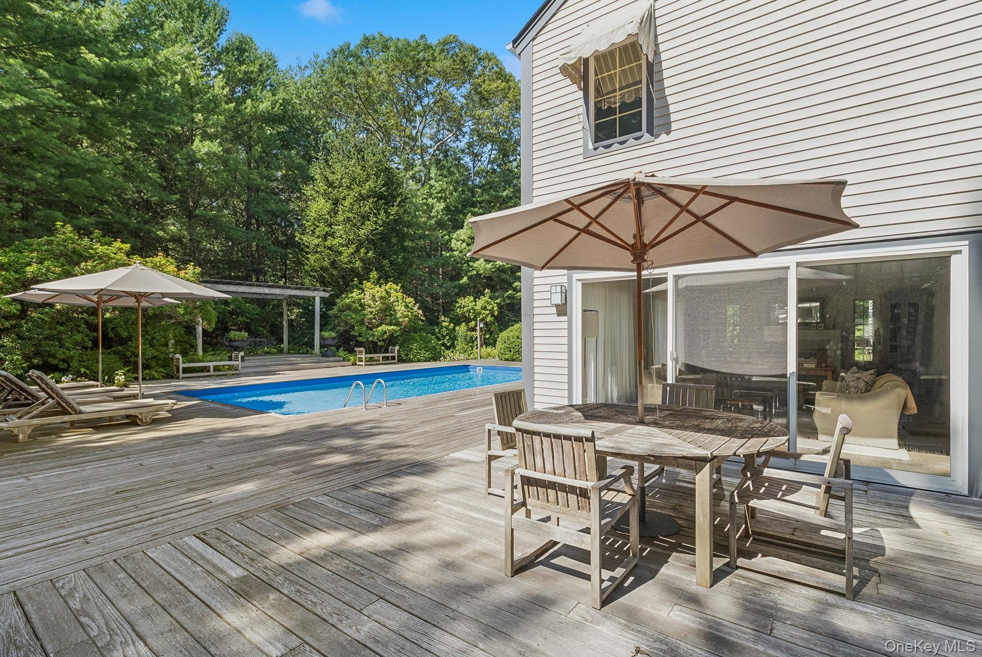530 Hands Creek Road East Hampton, NY 11937 - Photo 39 of 47 Outdoor pool with a wooden deck and outdoor dining area