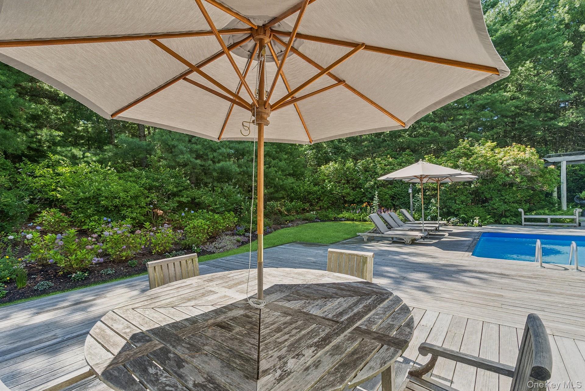 530 Hands Creek Road East Hampton, NY 11937 - Photo 40 of 47 Wooden terrace featuring outdoor dining area and an outdoor pool