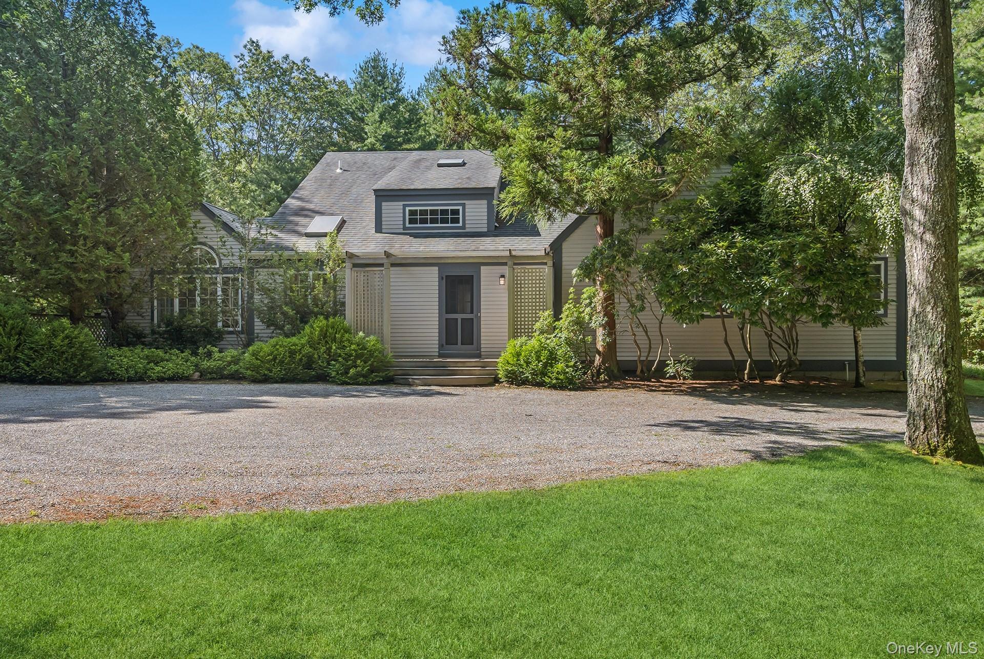 530 Hands Creek Road East Hampton, NY 11937 - Photo 8 of 47 Back of property with a yard and a shingled roof