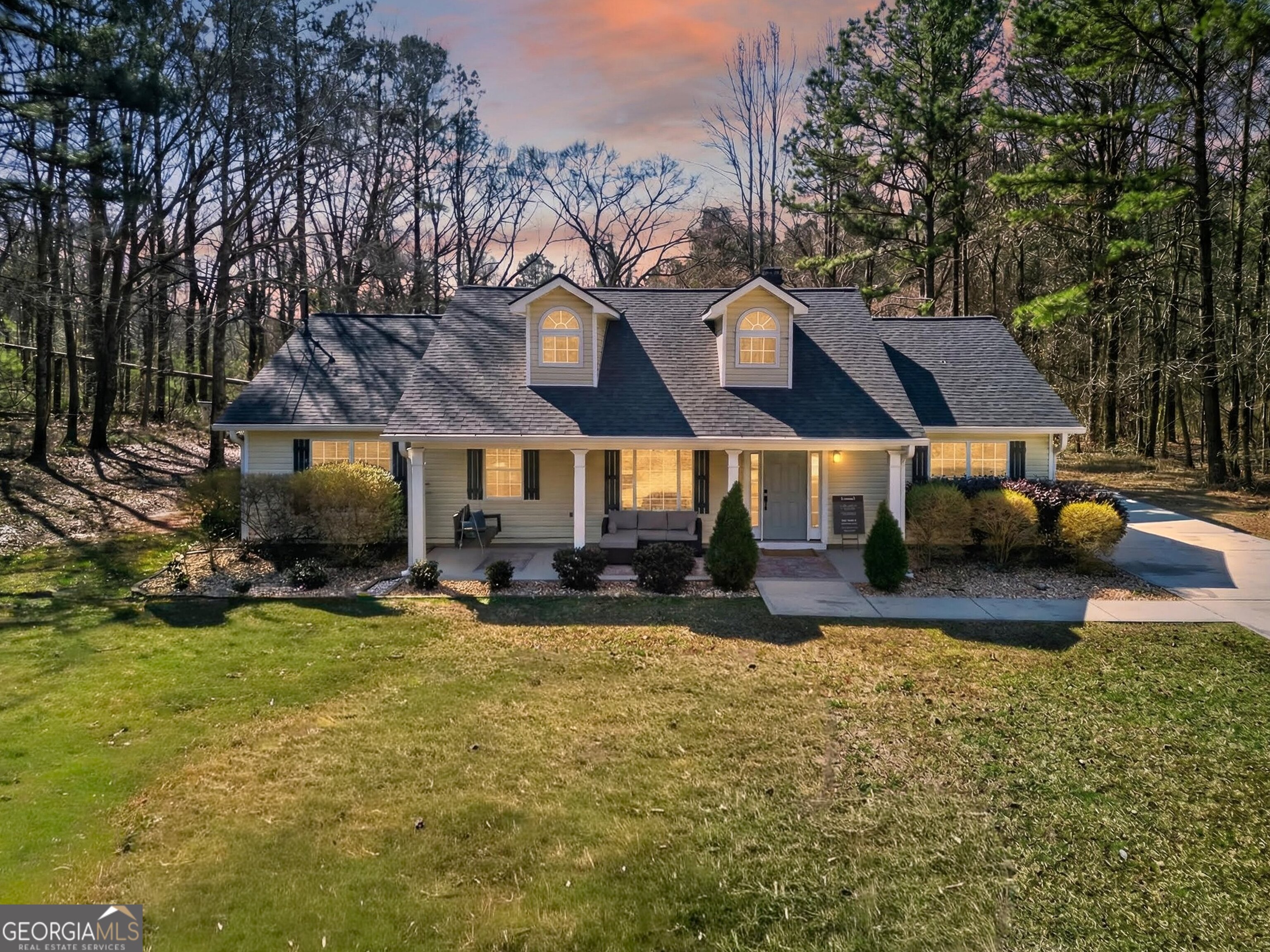 a view of a house with a yard patio and fire pit
