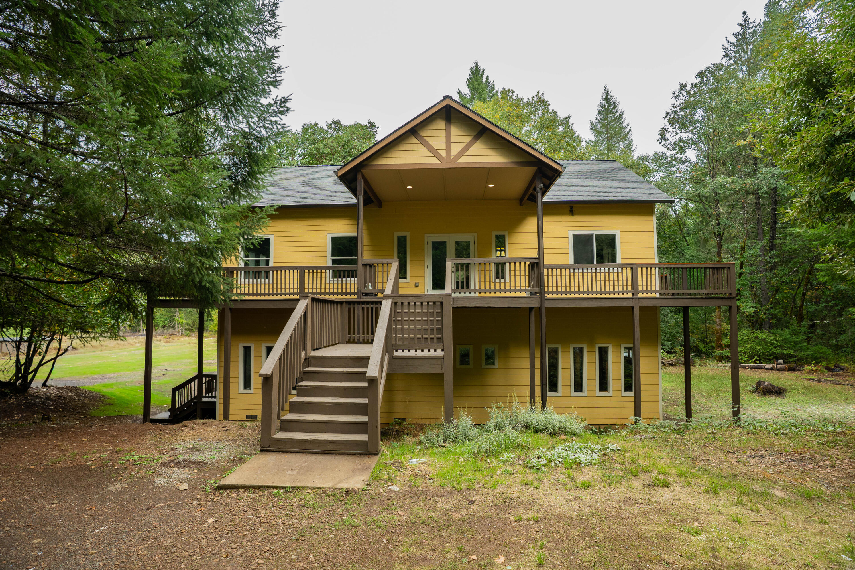 709 Pinewood Way Cave Junction, OR 97523 - Photo 3 of 24 a front view of a house with a yard