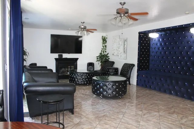 a living room with furniture a flat screen tv and a fireplace
