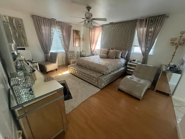 a bedroom with furniture and a large window