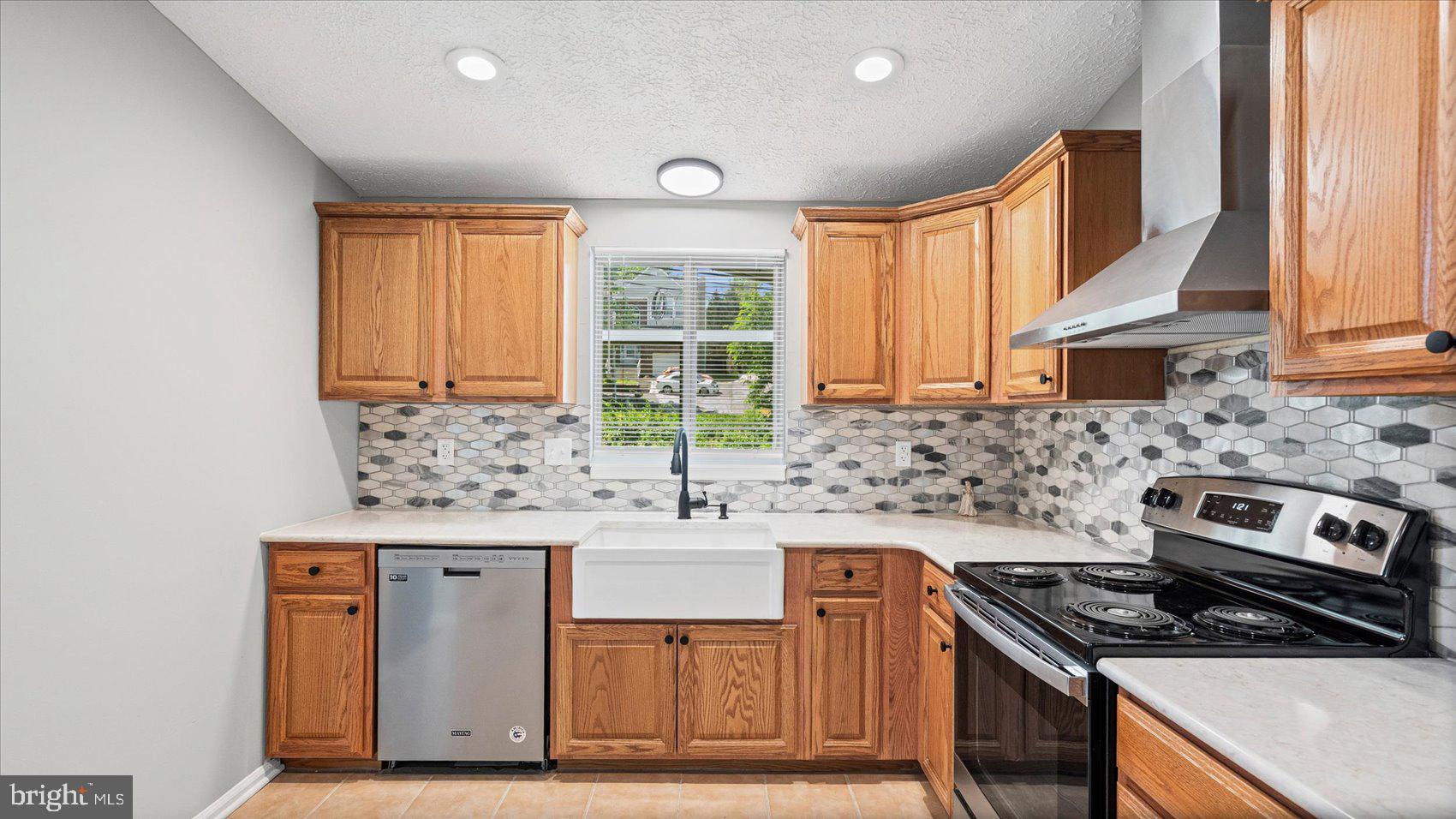 3709 Redberry Way Nottingham, MD 21236 - Photo 14 of 45 a kitchen with stainless steel appliances granite countertop a sink stove and cabinets