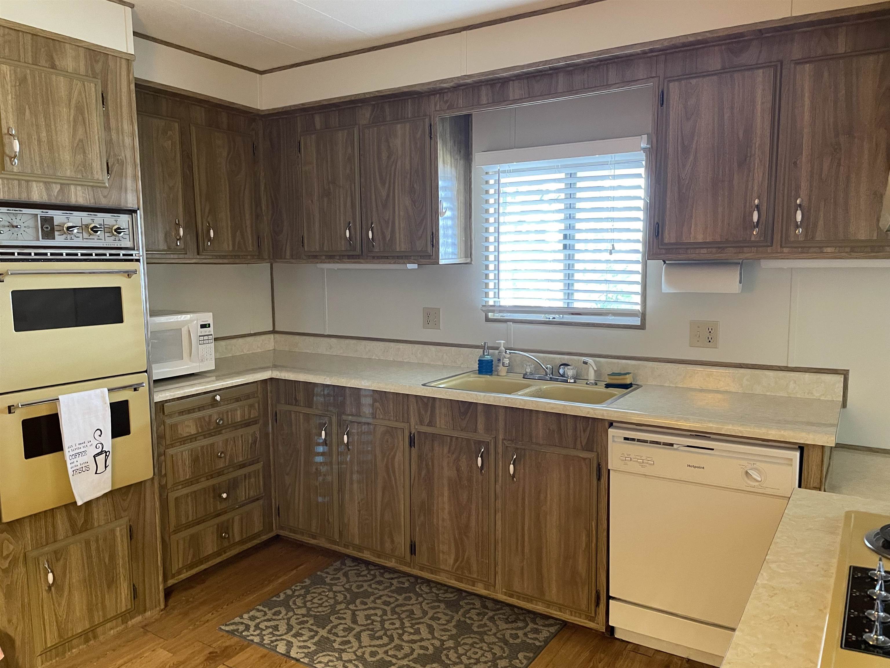 10956 Green Street, Unit 218 Columbia, CA 95310 - Photo 11 of 21 a kitchen with stainless steel appliances a stove a sink and a microwave