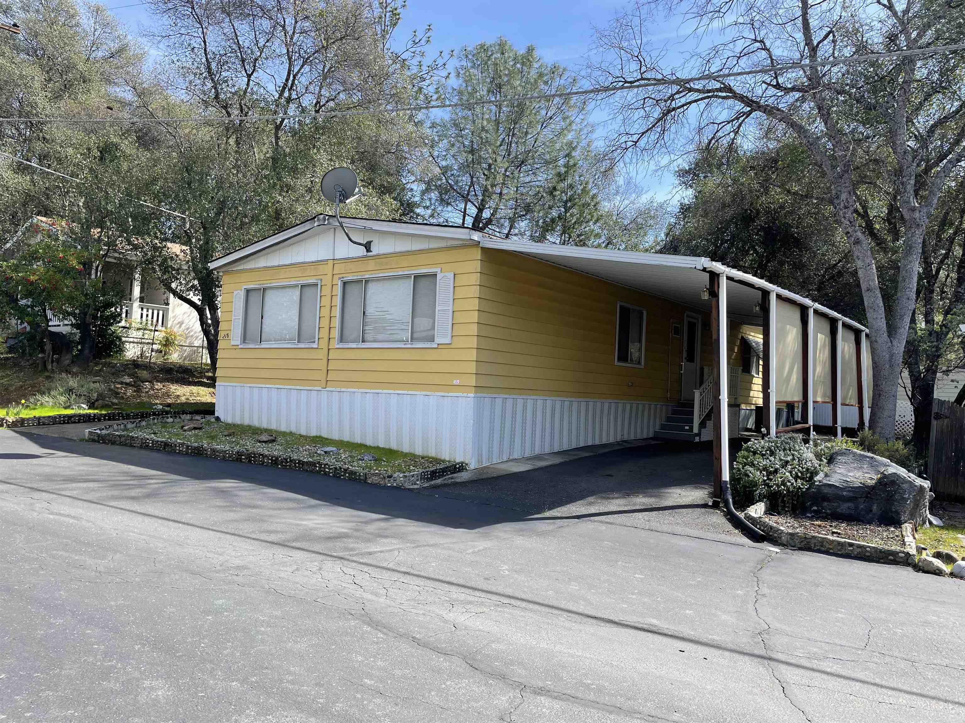 10956 Green Street, Unit 218 Columbia, CA 95310 - Photo 2 of 21 a front view of a house with garden