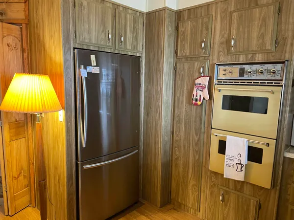 a kitchen with a refrigerator and stove