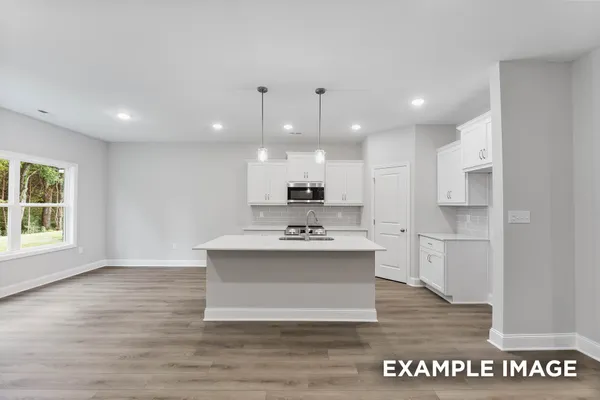 a view of kitchen with sink microwave and stove
