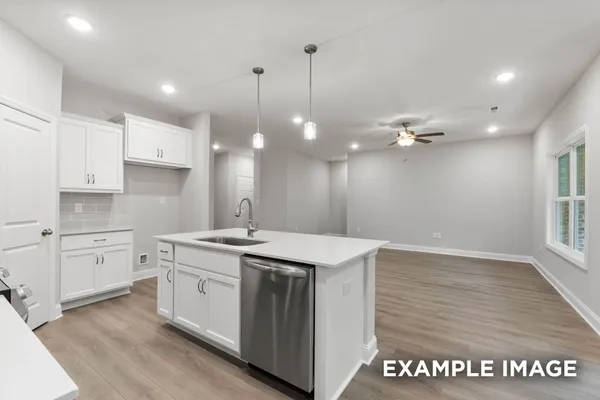a kitchen that has a sink a stove and cabinets