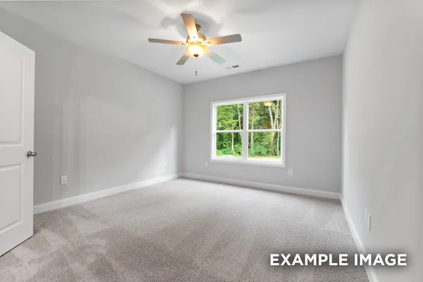 an empty room with windows and chandelier fan