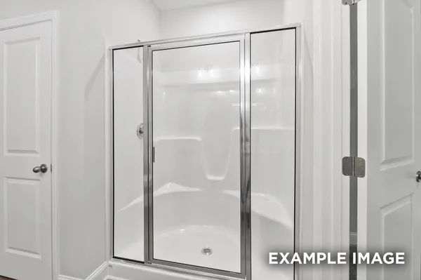 a bathroom with a glass shower door