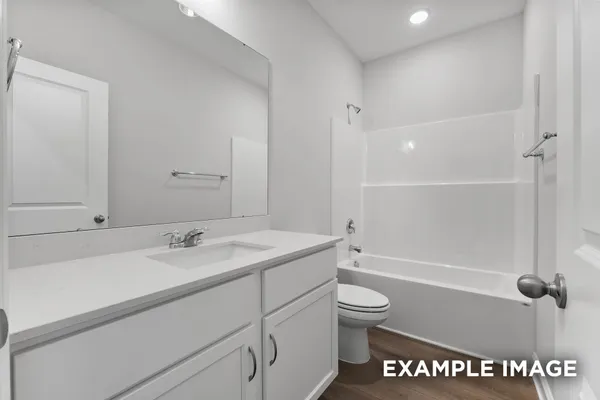 a bathroom with a granite countertop sink toilet a shower and a mirror