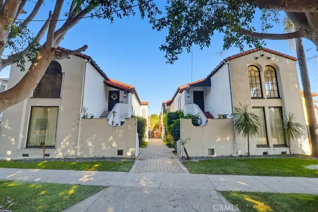 a front view of house with a garden