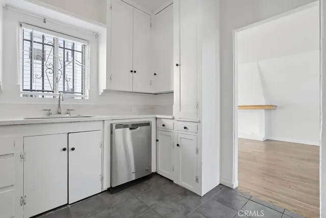 a view of a kitchen with white cabinets
