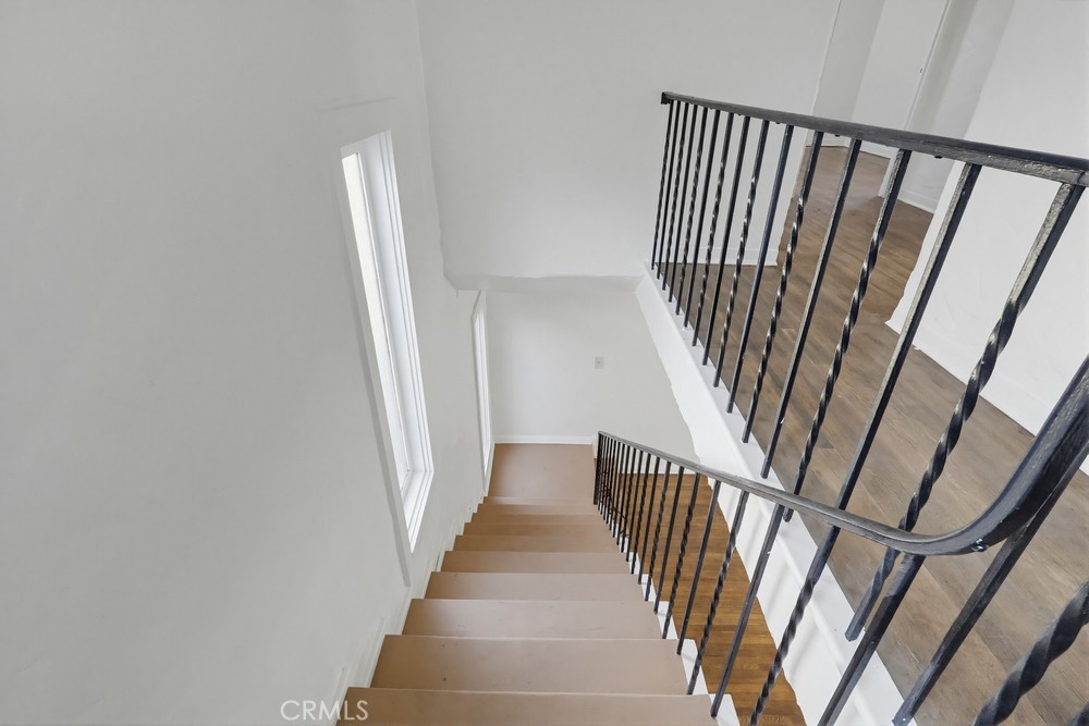 1527 East 3rd Street, Unit 1531 Long Beach, CA 90802 - Photo 18 of 38 a view of staircase with wooden floor and white walls