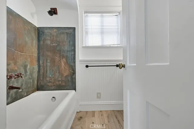 a bathroom with a bathtub and a shower
